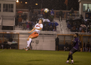 Stangeland heads the ball as rain falls. 